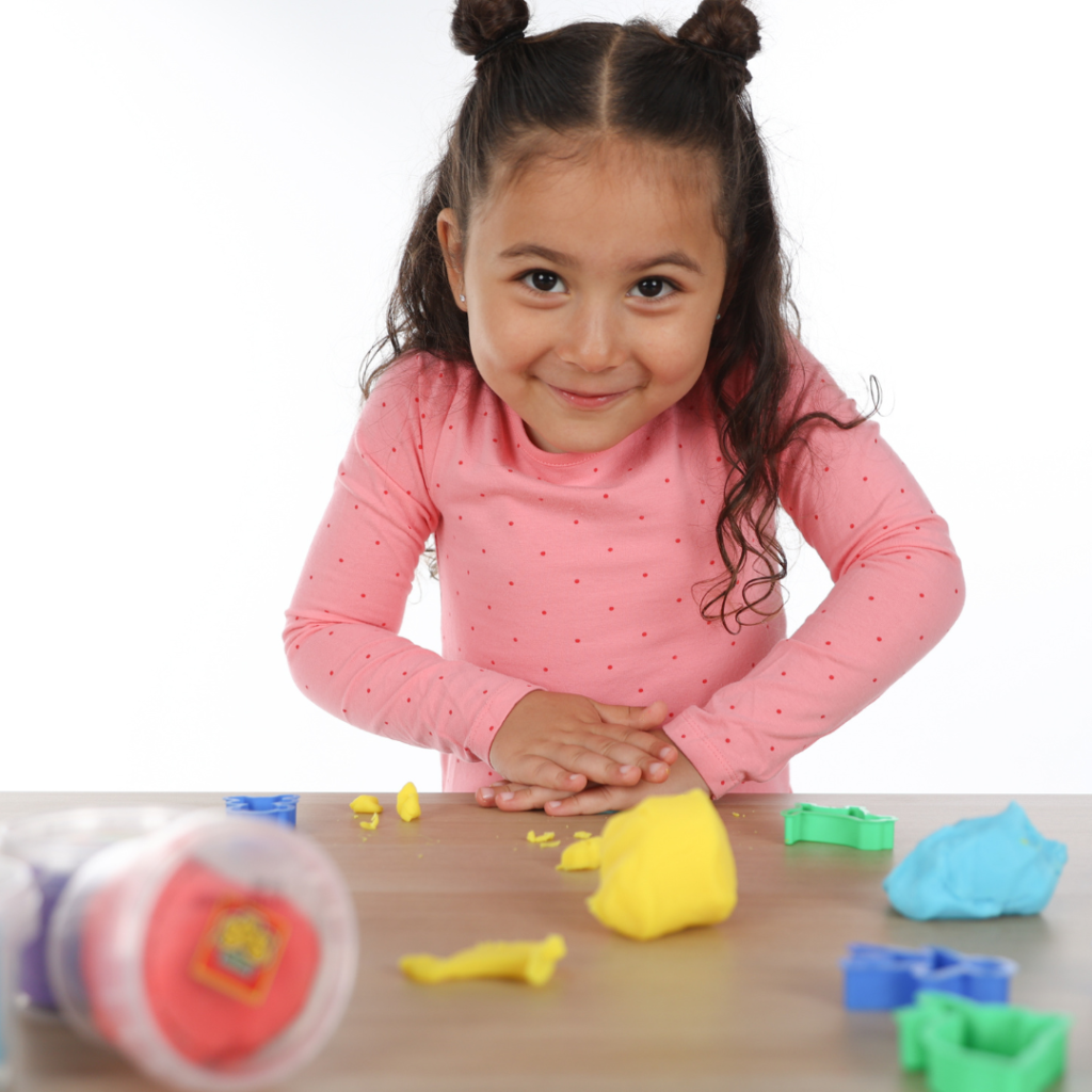 Girl playing with SES dough.